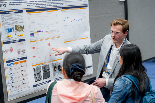 people standing beside a poster